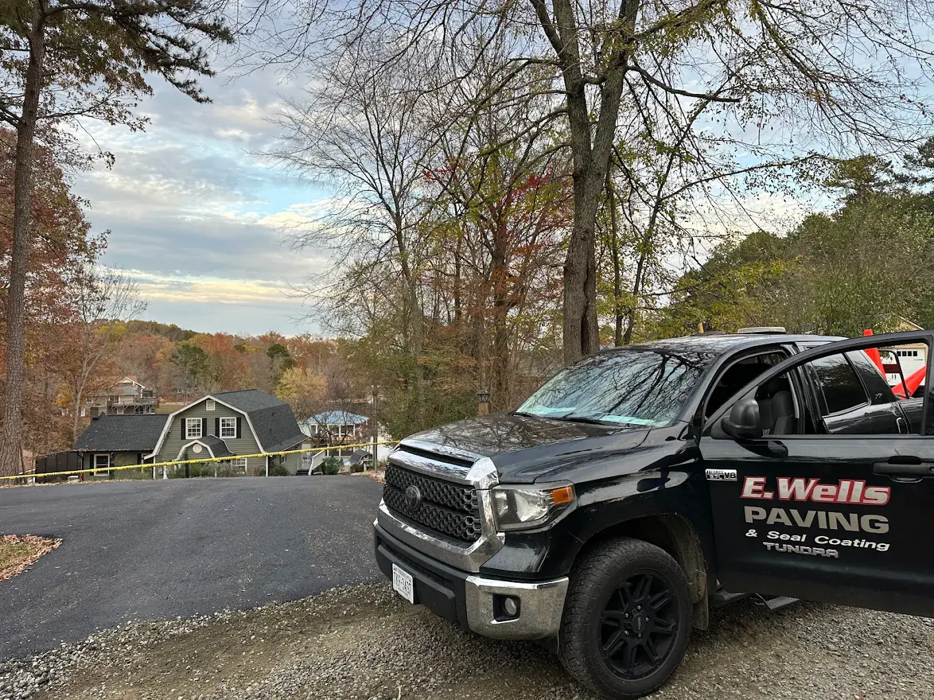 E Wells Paving work truck beside a driveway project